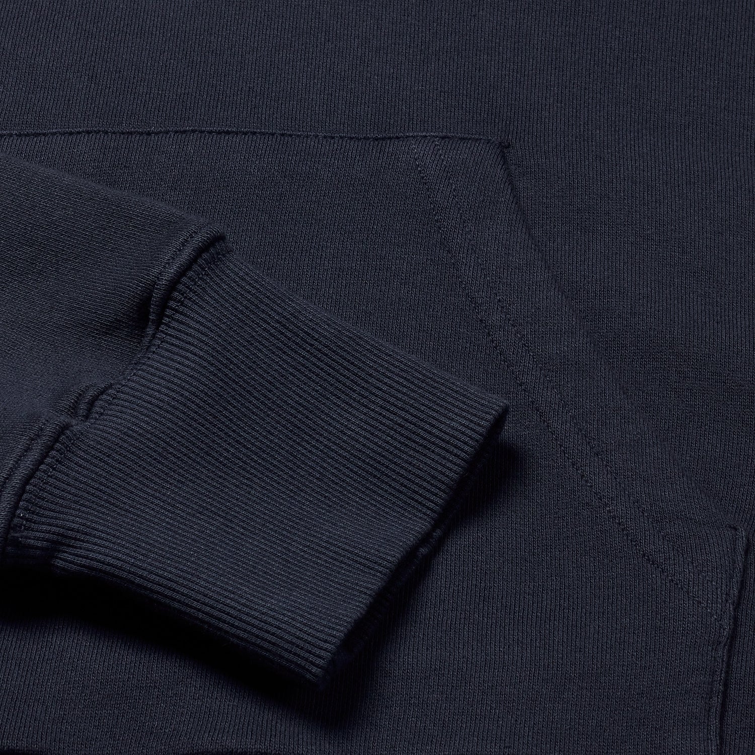 Close-up of navy hoodie's fabric showing fine texture detail.