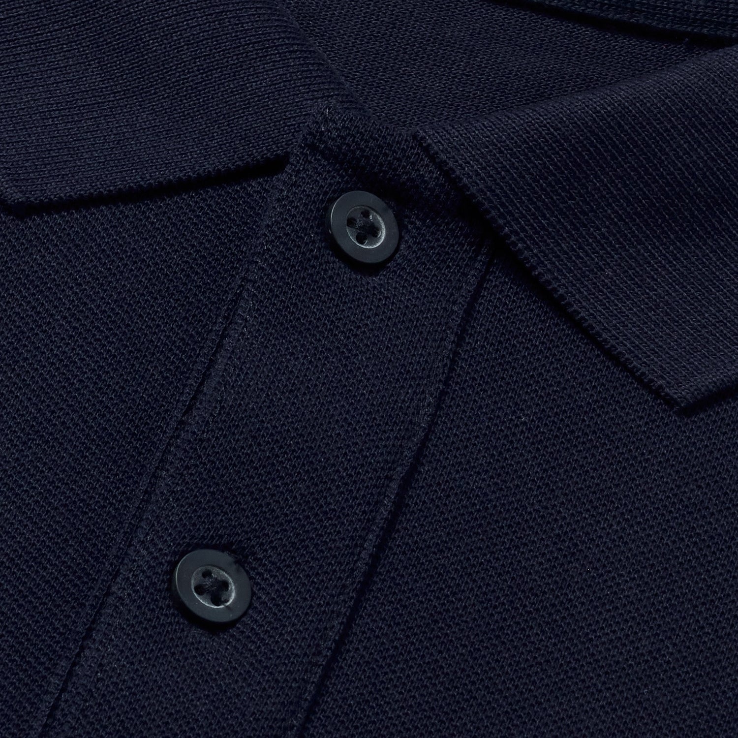 Close-up of navy polo collar and buttons.