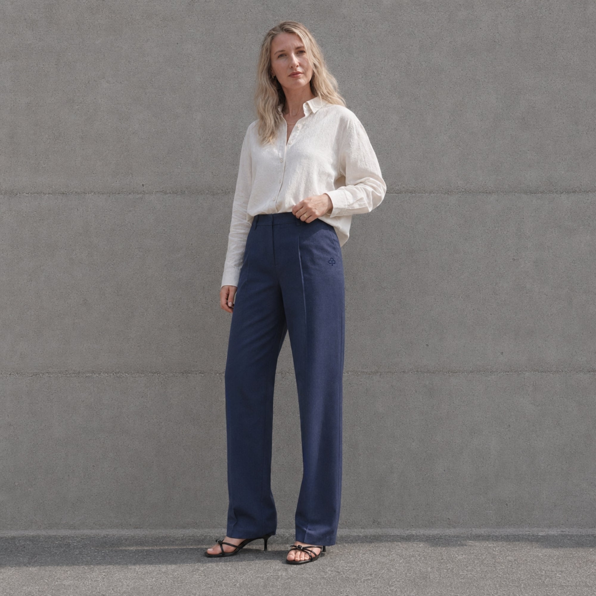 Pantaloni in lino straight leg blu navy, vista lifestyle 1, con pince e linea dellstraight leg